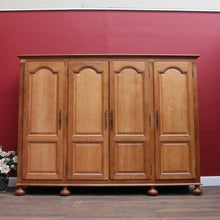 Load image into Gallery viewer, Antique French Oak 4 Door Armoire/ Wardrobe with hanging space shelves and three keys. B12743