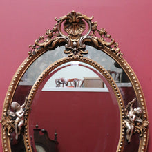 Load image into Gallery viewer, Vintage French Giltwood Oval Cushion Mirror with Silver Toned Cherubs and Rococo Gold Leaf Detail. B13047