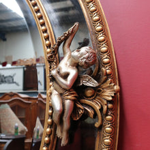 Load image into Gallery viewer, Vintage French Giltwood Oval Cushion Mirror with Silver Toned Cherubs and Rococo Gold Leaf Detail. B13047