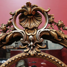 Load image into Gallery viewer, Vintage French Giltwood Oval Cushion Mirror with Silver Toned Cherubs and Rococo Gold Leaf Detail. B13047