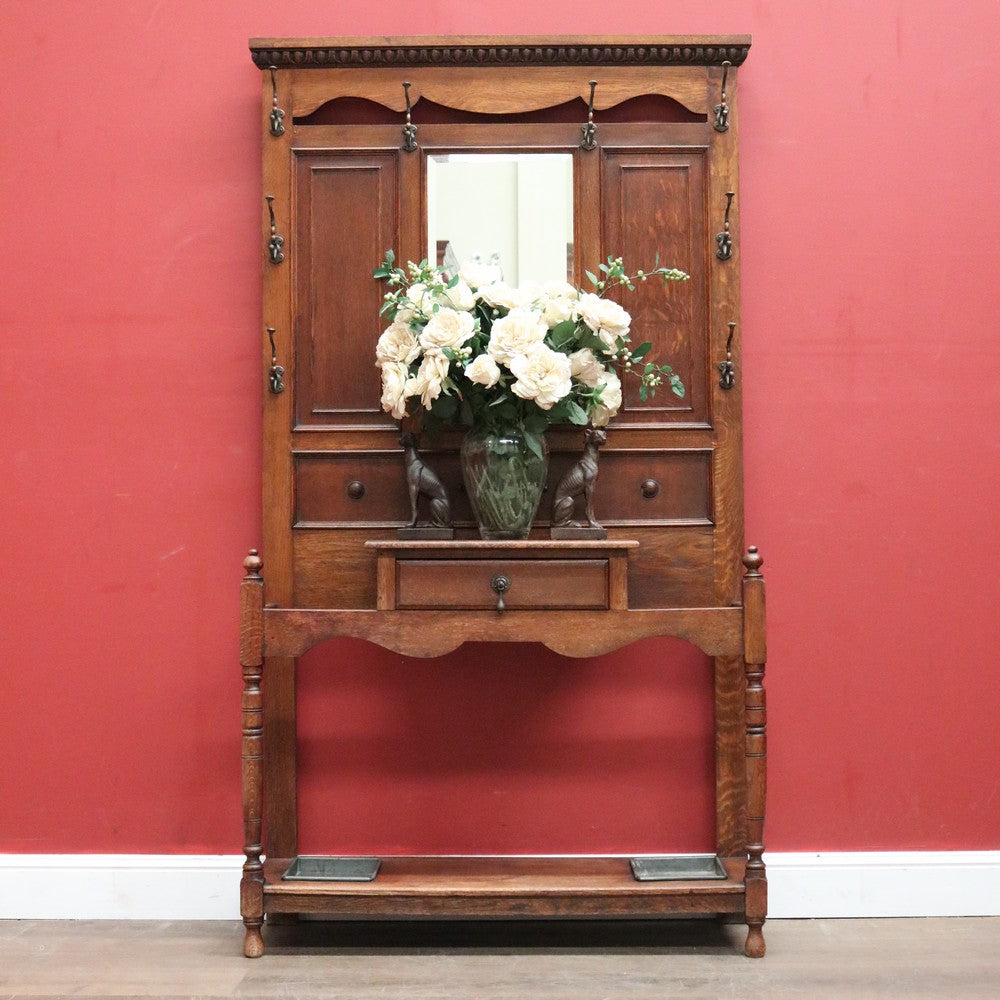 Antique English Oak Hall Stand with a Bevelled Mirror and Eight Coat or Hat Hooks. B11974