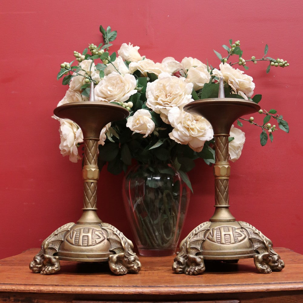A pair of antique French candlestick holders, brass candle holders, and gargoyle feet. B11963