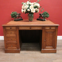 Load image into Gallery viewer, Antique English oak and tan leather office desk with drawers and cupboard. B12635
