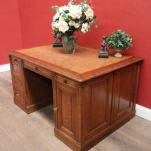 Load image into Gallery viewer, Antique English oak and tan leather office desk with drawers and cupboard. B12635
