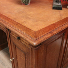 Load image into Gallery viewer, Antique English oak and tan leather office desk with drawers and cupboard. B12635
