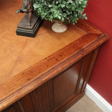Load image into Gallery viewer, Antique English oak and tan leather office desk with drawers and cupboard. B12635
