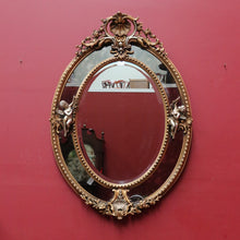 Load image into Gallery viewer, Vintage French Giltwood Oval Cushion Mirror with Silver Toned Cherubs and Rococo Gold Leaf Detail. B13047
