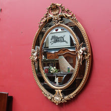 Load image into Gallery viewer, Vintage French Giltwood Oval Cushion Mirror with Silver Toned Cherubs and Rococo Gold Leaf Detail. B13047
