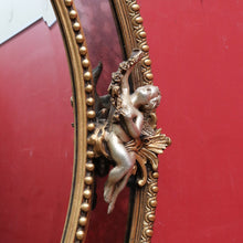 Load image into Gallery viewer, Vintage French Giltwood Oval Cushion Mirror with Silver Toned Cherubs and Rococo Gold Leaf Detail. B13047
