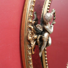 Load image into Gallery viewer, Vintage French Giltwood Oval Cushion Mirror with Silver Toned Cherubs and Rococo Gold Leaf Detail. B13047
