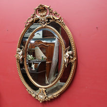 Load image into Gallery viewer, Vintage French Giltwood Oval Cushion Mirror with Silver Toned Cherubs and Rococo Gold Leaf Detail. B13047
