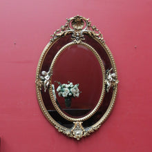 Load image into Gallery viewer, Vintage French Giltwood Oval Cushion Mirror with Silver Toned Cherubs and Rococo Gold Leaf Detail. B13047
